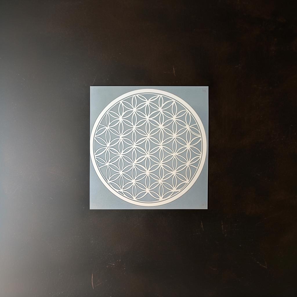 Flower of Life stencil on blue background, perfect for DIY wall painting and sacred geometry decor.