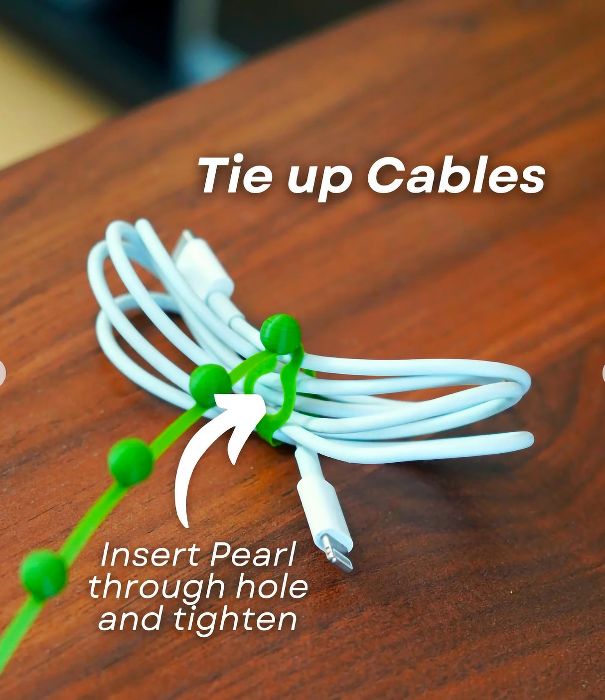 Cable organizer showing green plant-inspired ties holding cables neatly together on a desk.