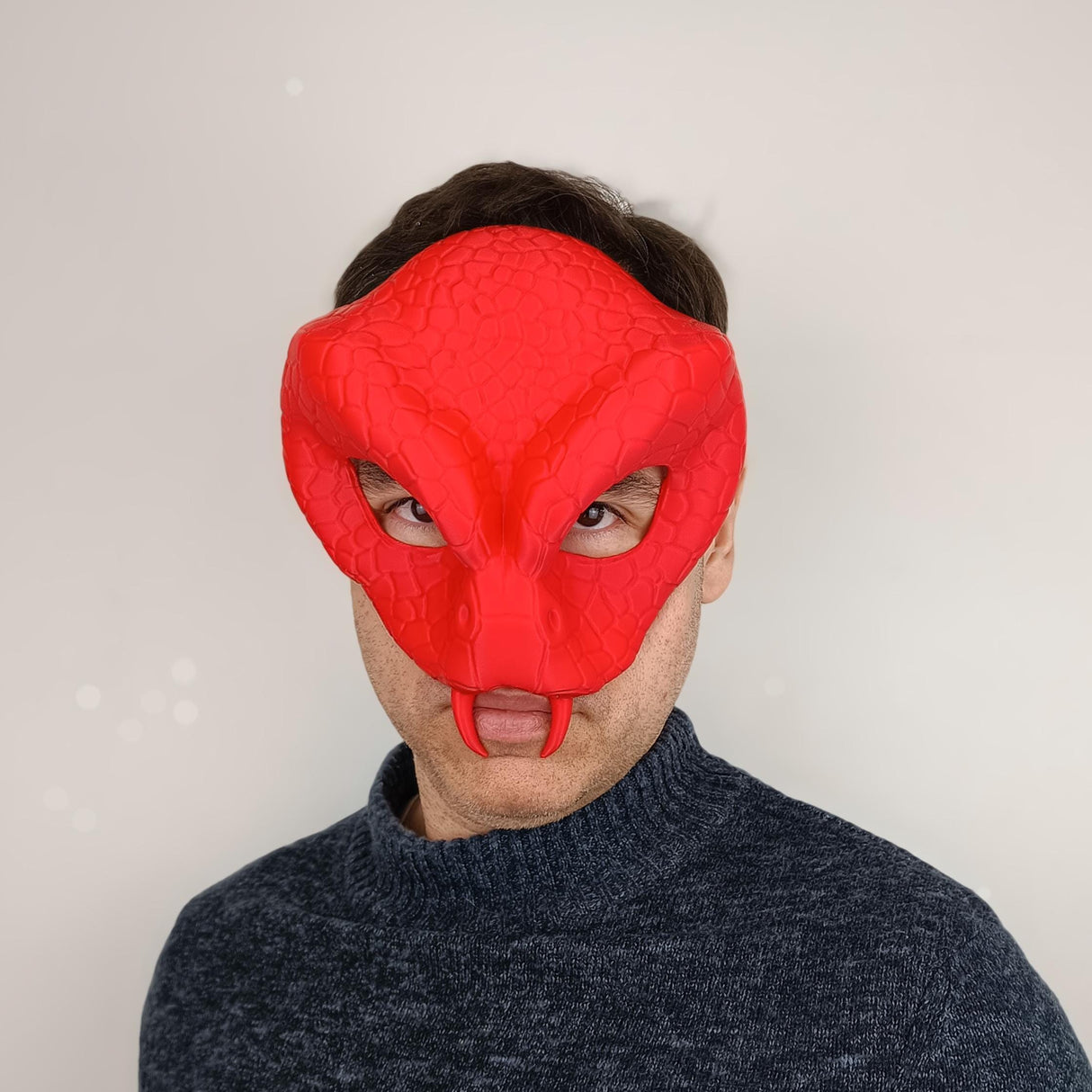 3D printed red snake demon mask worn by a man, showcasing realistic reptilian features for cosplay or Halloween.