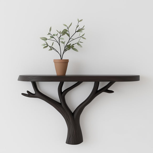 Tree branch wall shelf with a black matte finish and a potted plant, showcasing modern minimalist design.