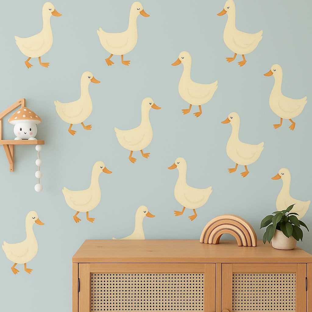 Whimsical yellow goose wall decals on a soft blue nursery wall, perfect for playful children's decor.