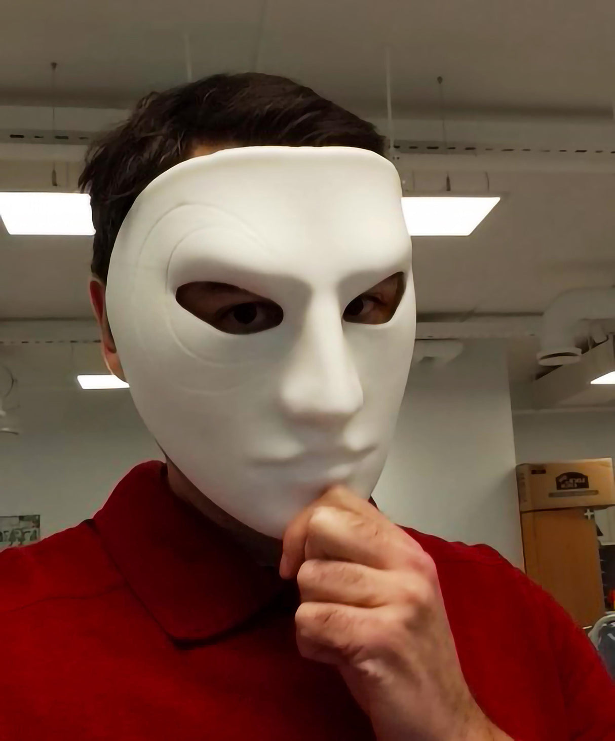 A matte white 3D printed full face mask with detailed swirl patterns near one eye, shown worn by a person and displayed from multiple angles, including front and close-up views, highlighting its smooth surface and artistic design.