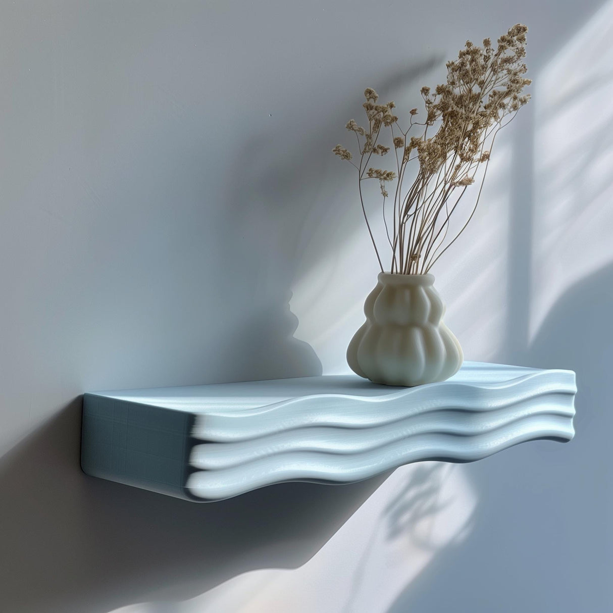 3D printed minimalist wavy wall shelf with ripple design, holding a vase, modern matte PLA texture in natural daylight