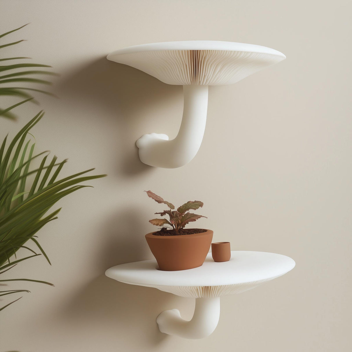 "Set of two white 3D printed mushroom-inspired wall shelves with curved stems, styled with a terracotta plant pot against a neutral beige wall."
