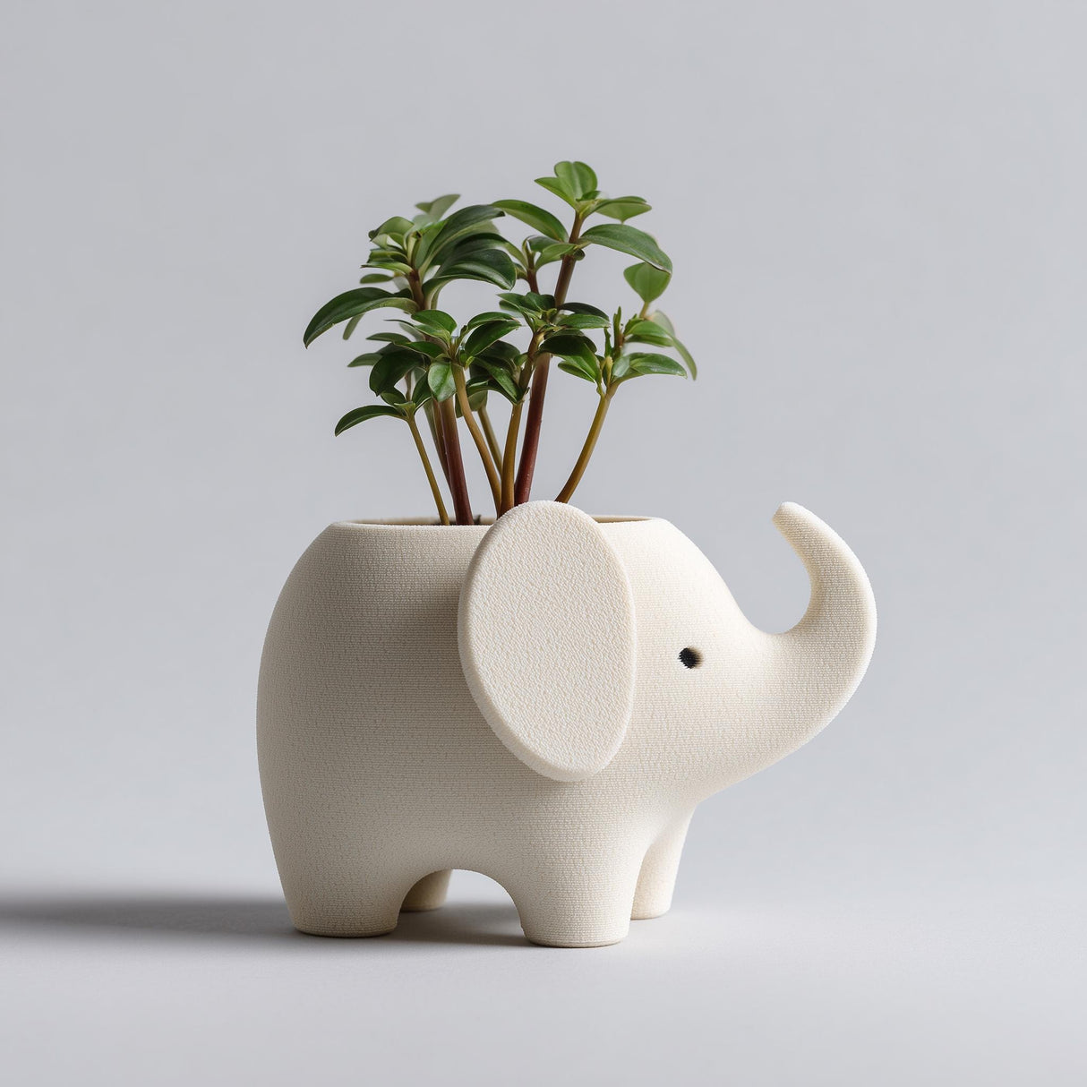 3D printed elephant-shaped planter with an open top used as a small pot, standing on a neutral background.