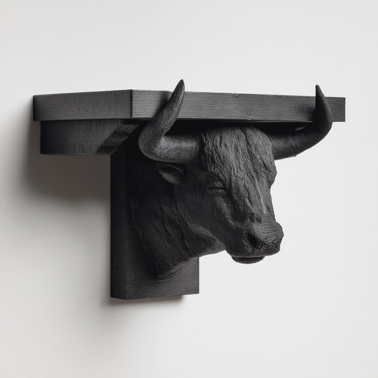 3D printed bull head wall shelf with long curved horns supporting a flat floating ledge, mounted on a clean minimalist wall.