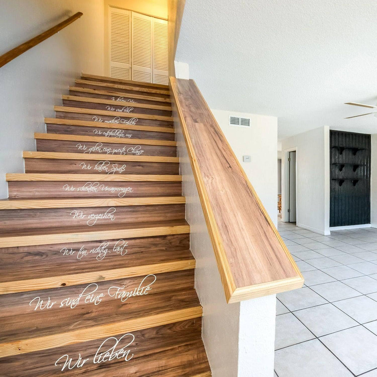 Stylish vinyl family quote decals on wooden staircase, adding charm to home decor with elegant design.