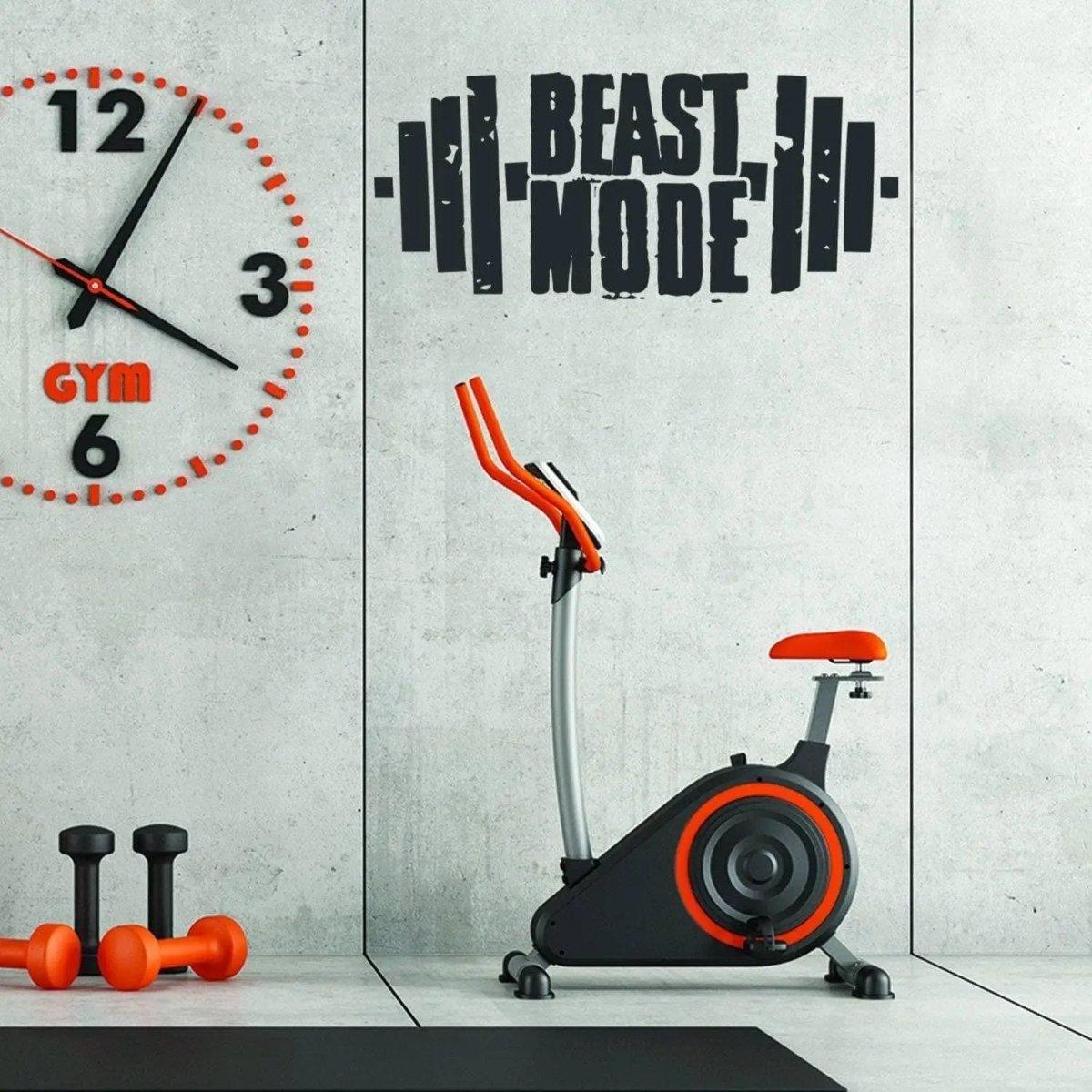 Beast Mode motivational wall decal in gym with exercise bike and weights for workout inspiration.