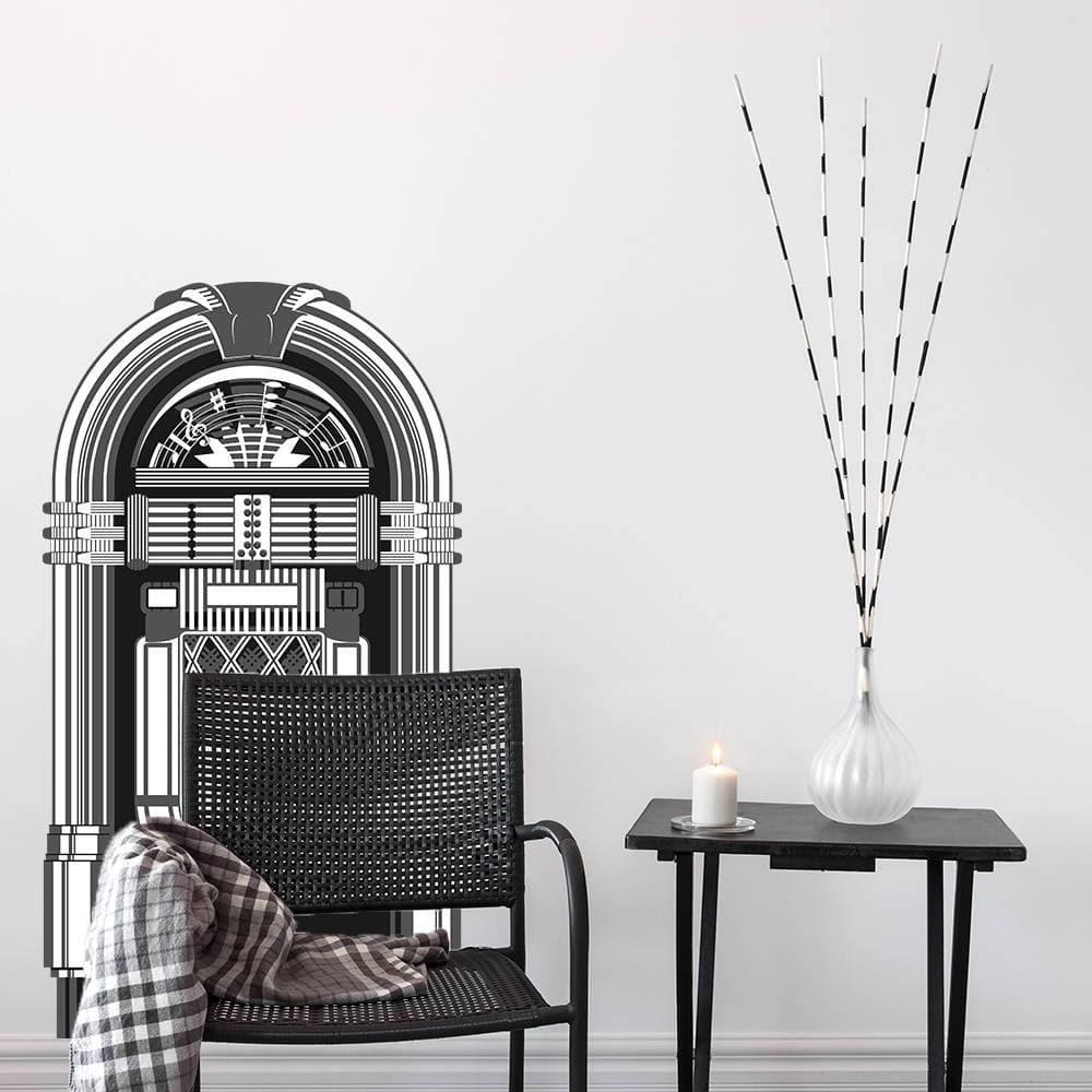 Retro jukebox vinyl wall decal adding vintage charm to a modern room decor with minimalist furniture.