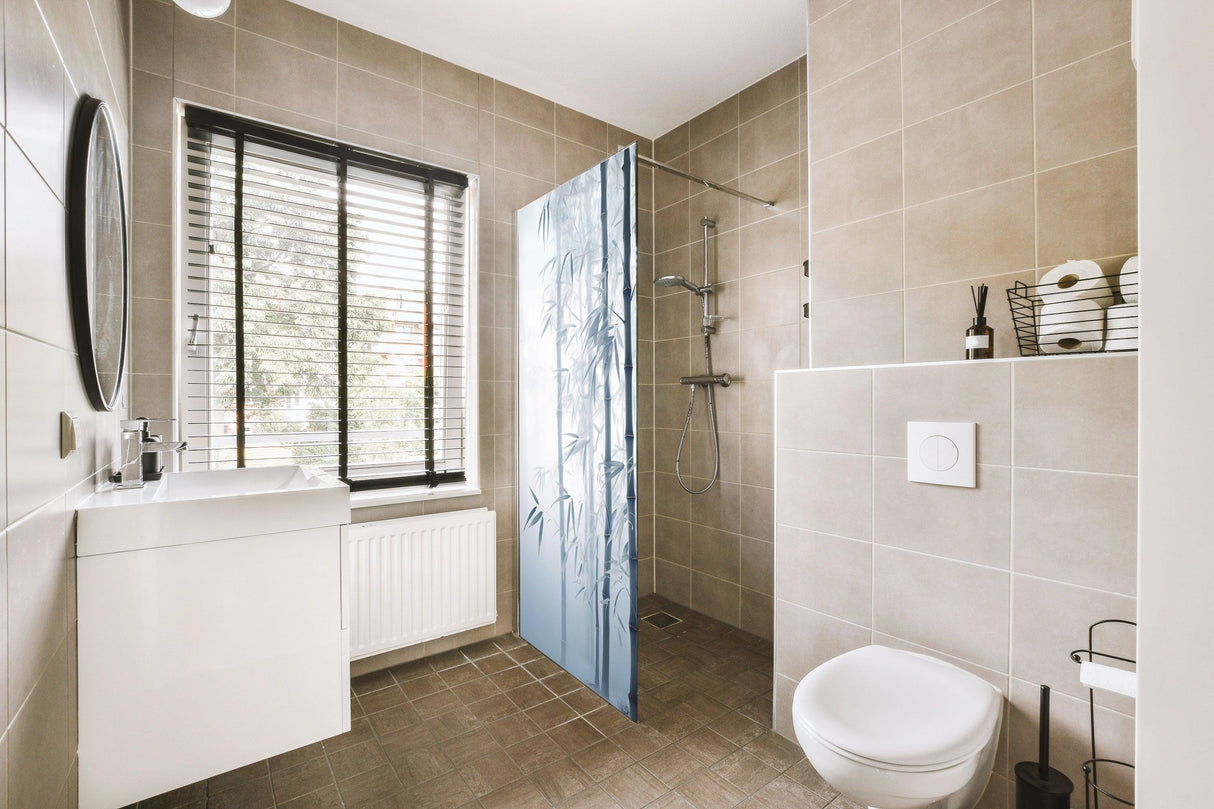 Modern bathroom featuring a tranquil shower door decal with a bamboo forest design for privacy.
