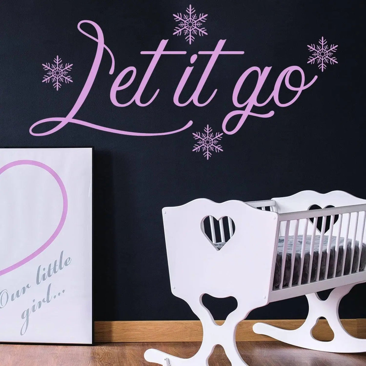 Inspirational Let It Go wall sticker with snowflakes in a nursery setting, featuring white crib and dark wall.