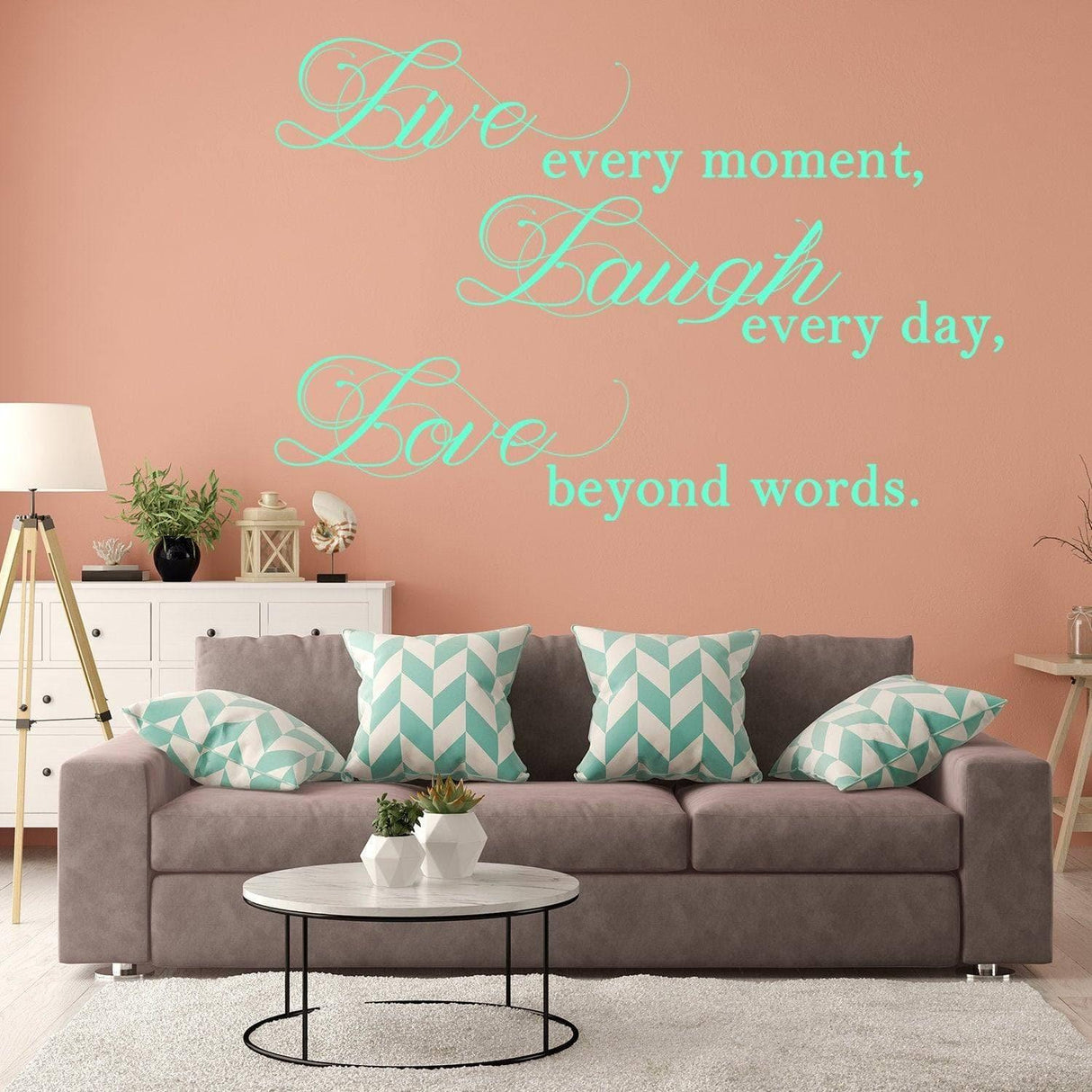Elegant vinyl wall decal with the quote 'Live every moment, Laugh every day, Love beyond words' on pink wall.