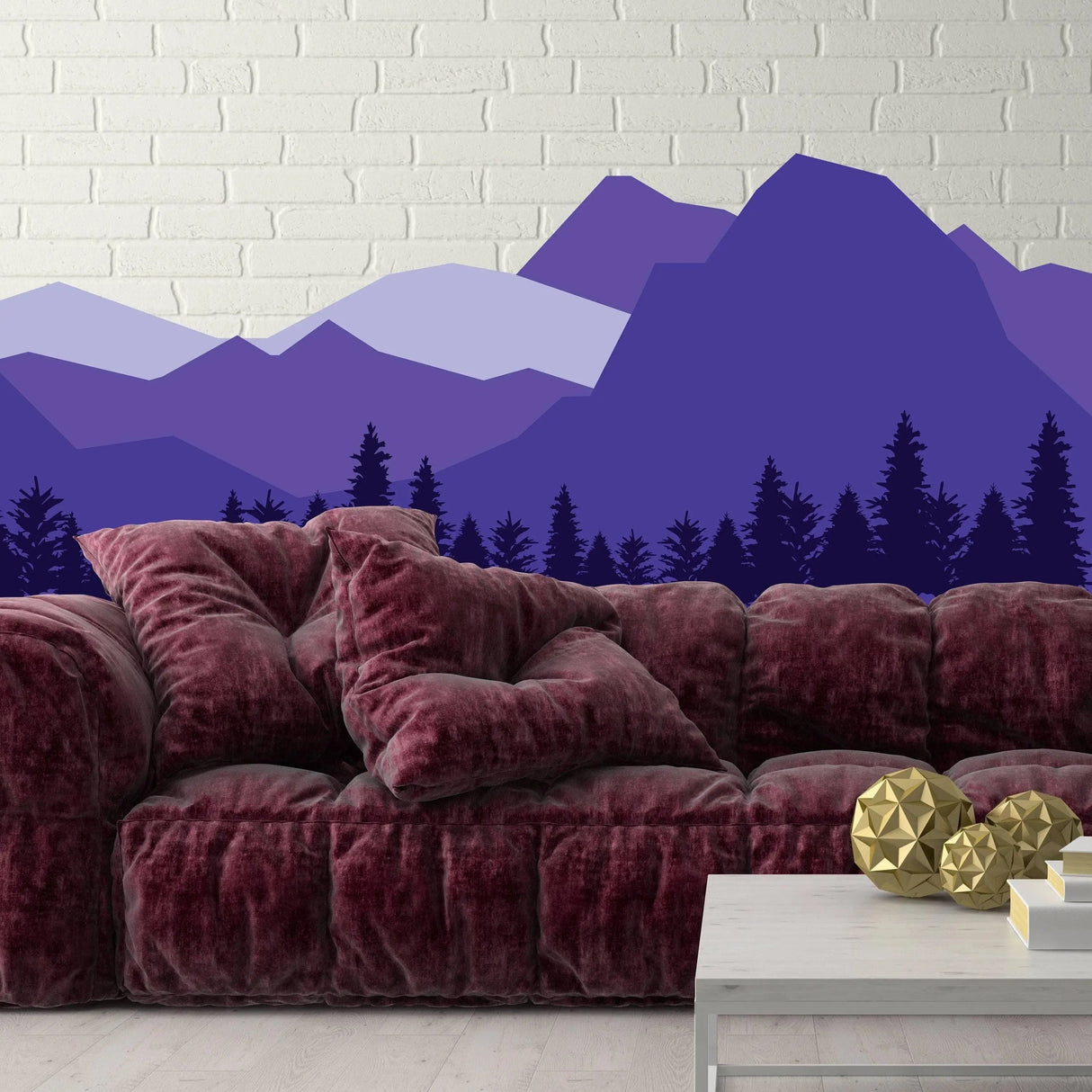 Vibrant mountain wall decal in purple tones above a cozy burgundy sofa, enhancing interior decor.
