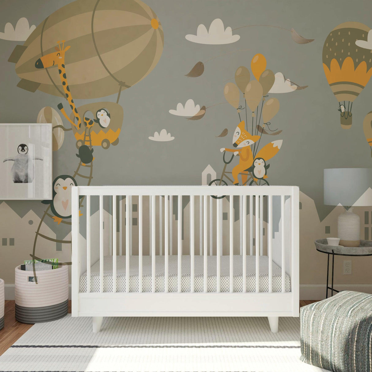 Stylish nursery featuring whimsical wall decals of penguins and foxes with hot air balloons, perfect for kids' rooms.