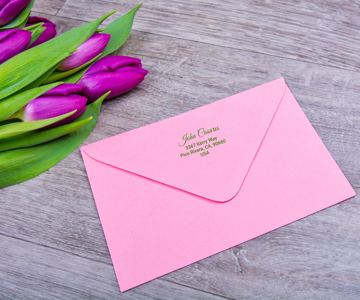 Personalized pink envelope with flower bouquet and custom address label design for stylish mailing.