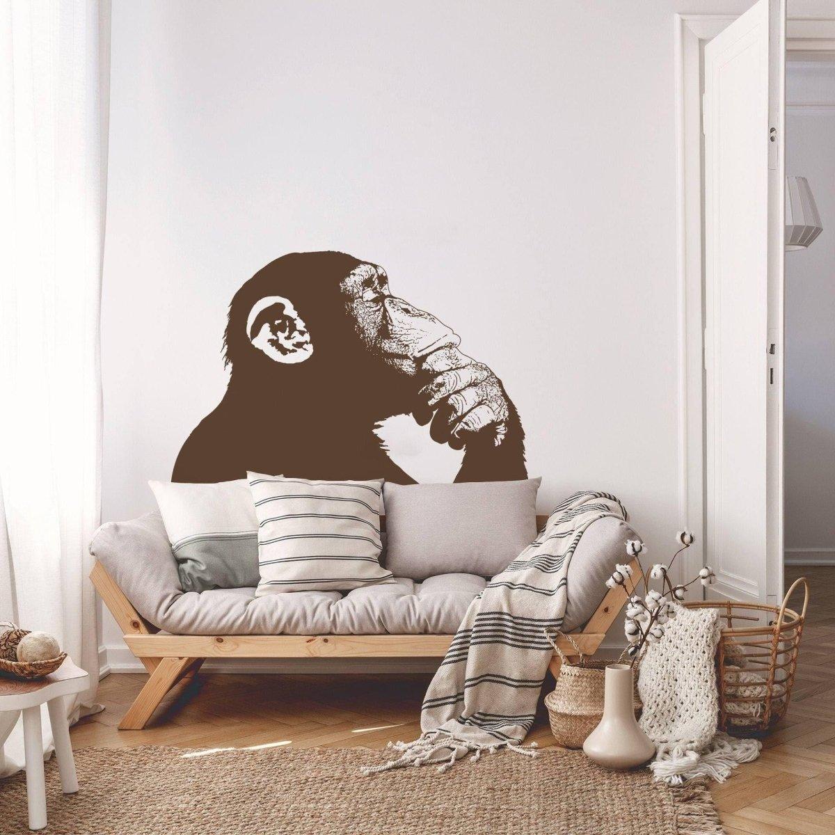 Thinking monkey wall sticker vinyl decal enhancing living room decor with stylish sofa and cozy accessories.