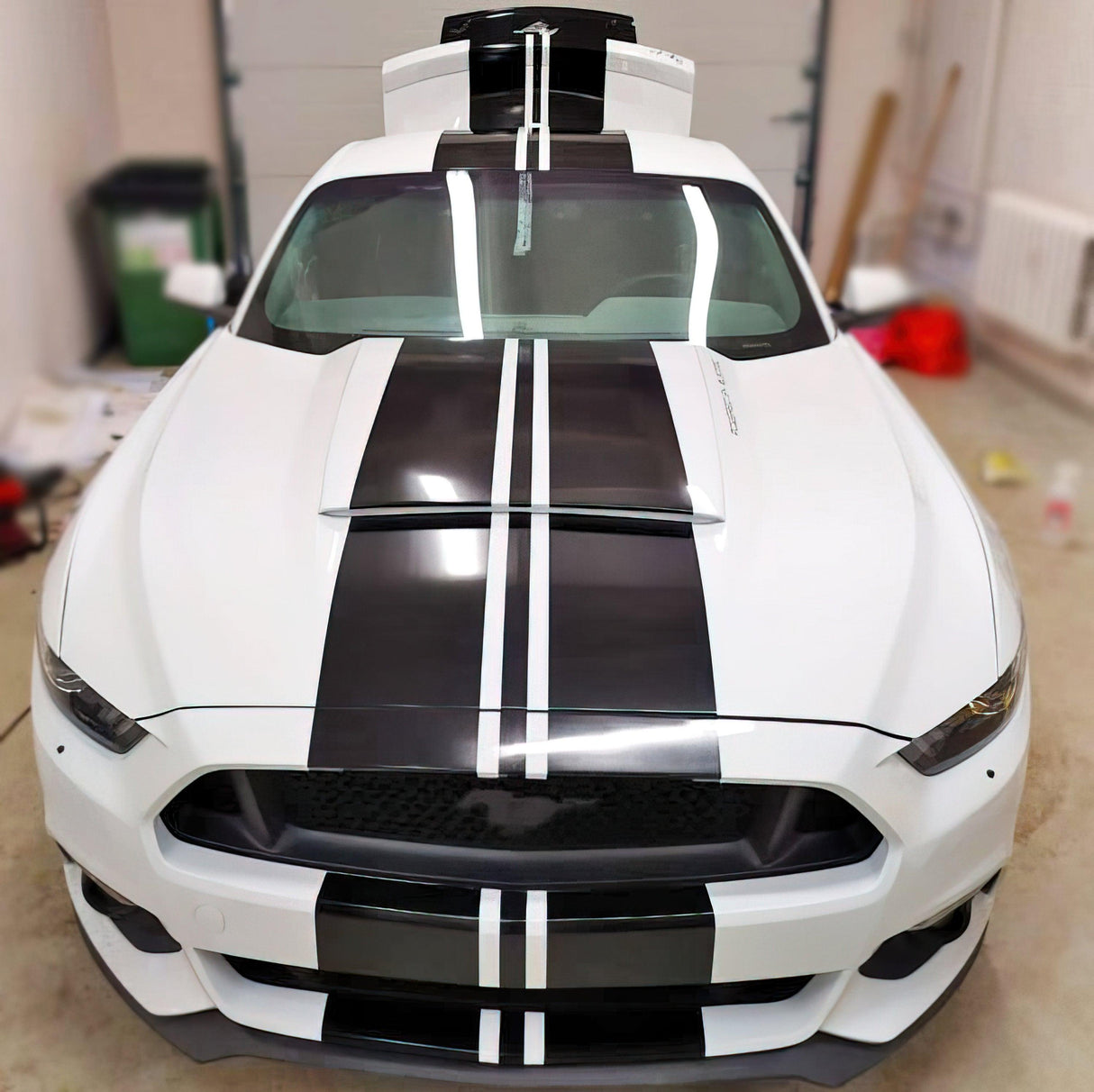 White car with sleek black racing stripes vinyl decals for sporty upgrade.