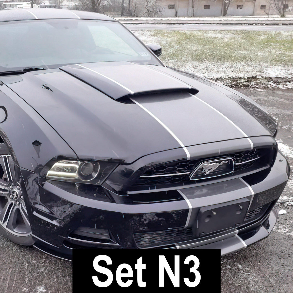 Black car featuring sleek racing stripes vinyl decals, showcasing sporty design and upgraded look.