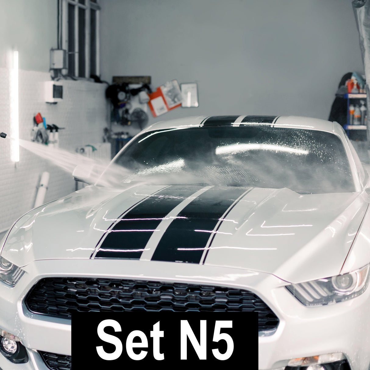 White car with racing stripes being rinsed, showcasing the Racing Stripes Car Stickers in action.
