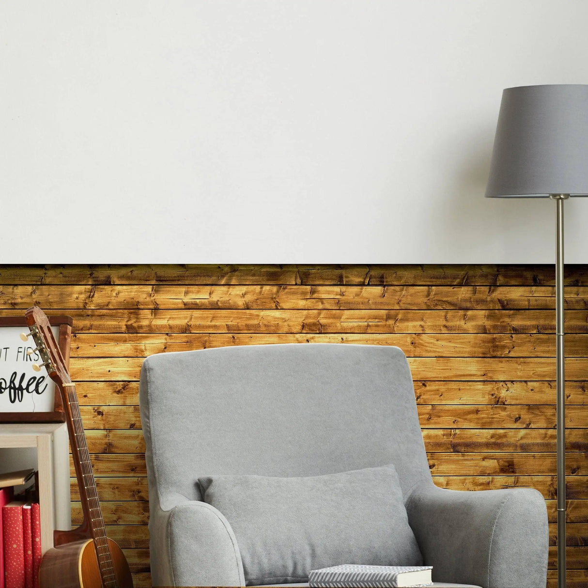 Cozy living room featuring beige chair with rustic wood plank wallpaper and stylish lamp, creating a warm atmosphere.