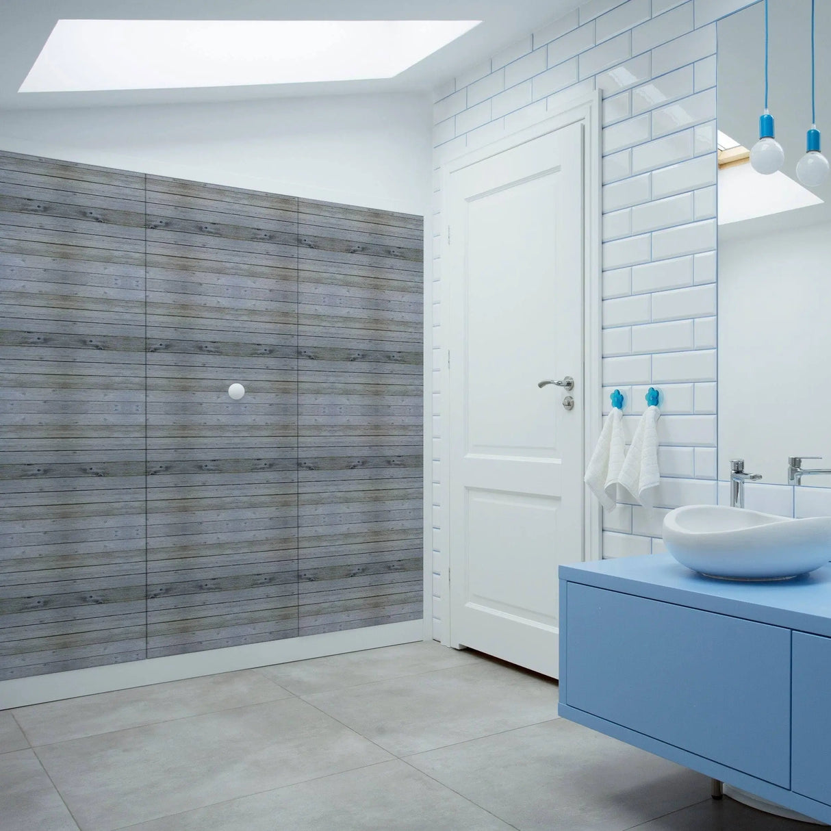Rustic wood plank wall decal in modern bathroom with blue accents and white tiles, showcasing easy peel and stick functionality.