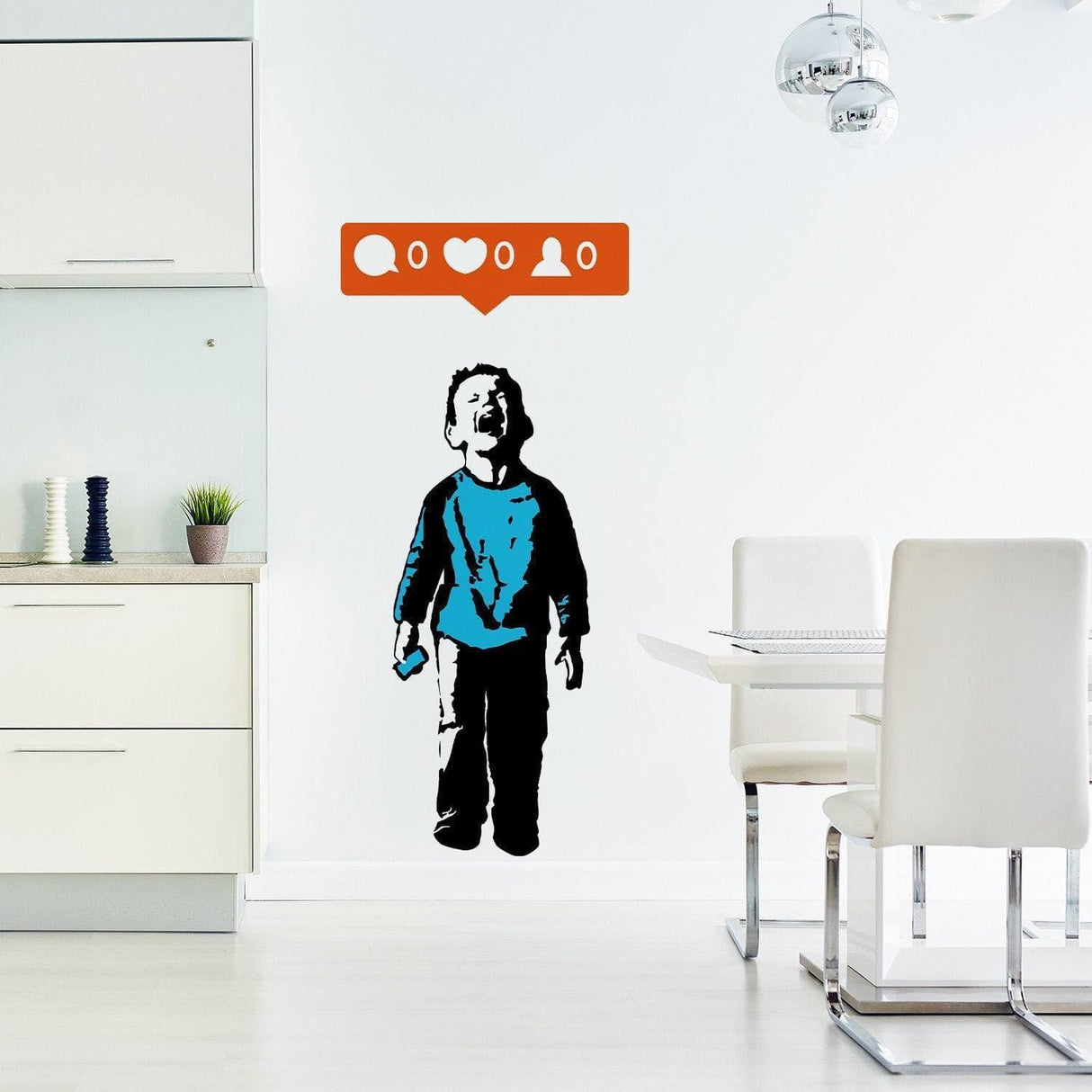Banksy-style crying boy wall decal with social media icons in a modern kitchen setting.