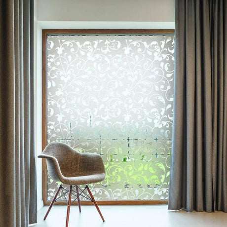 Stylish frosted privacy glass film on window with elegant pattern, paired with curtains and modern chair.