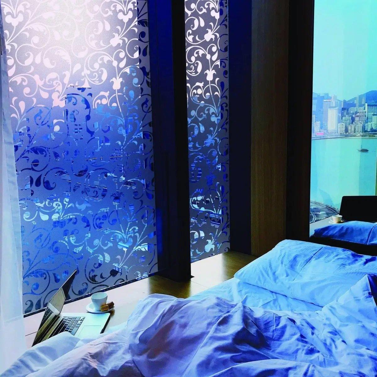 Stylish frosted window film in a modern bedroom, providing privacy while allowing natural light to enter.