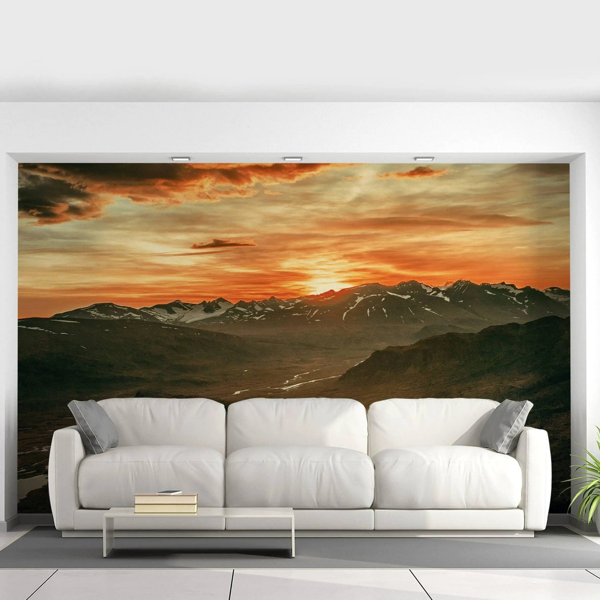 Majestic sunset wall mural above modern white couch, creating a breathtaking nature-inspired decor.