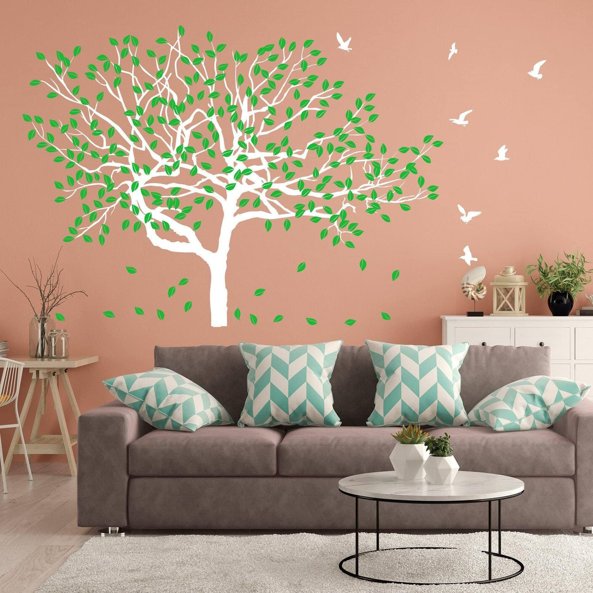Serenity Tree Wall Sticker with green leaves on a peach wall, enhancing a cozy living room decor.