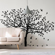 Nature-inspired tree wall decal sticker for home decoration, featuring leaves and birds in black silhouette.