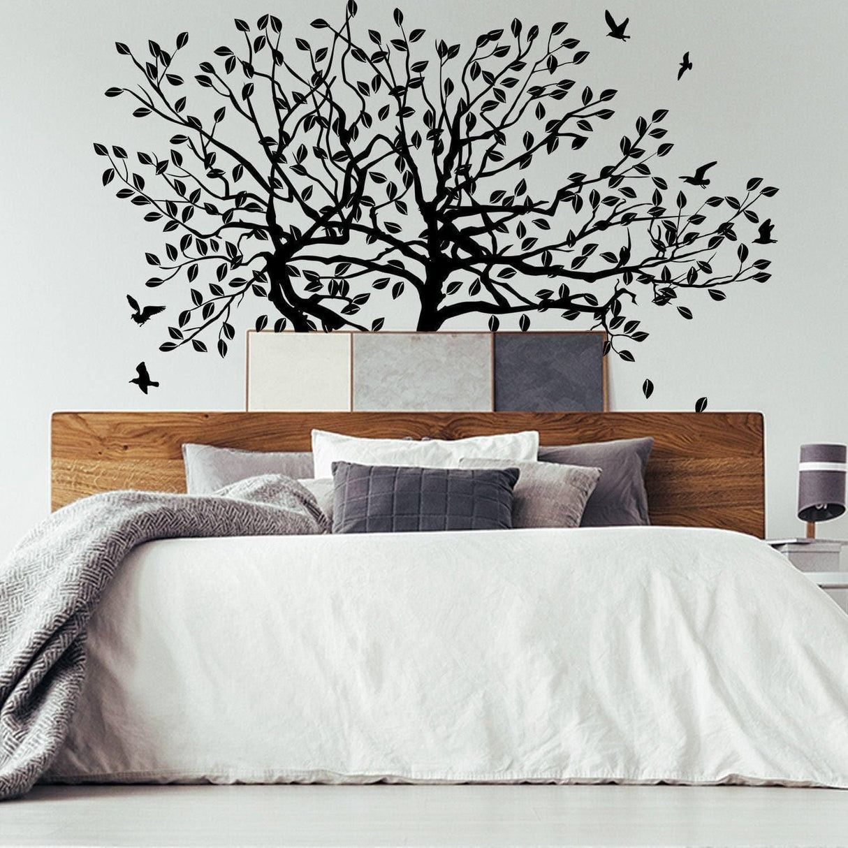 Nature-inspired tree wall decal above a cozy bed, adding a serene touch to home decor.