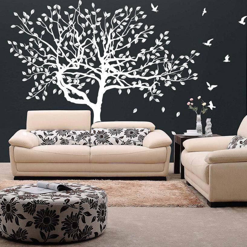 Nature-inspired tree wall decal enhancing modern living room decor with birds and stylish furniture.