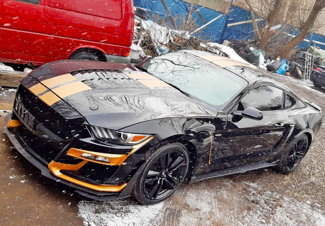 Stylish black car with racing stripes, showcasing vibrant decals for an upgraded vehicle look.