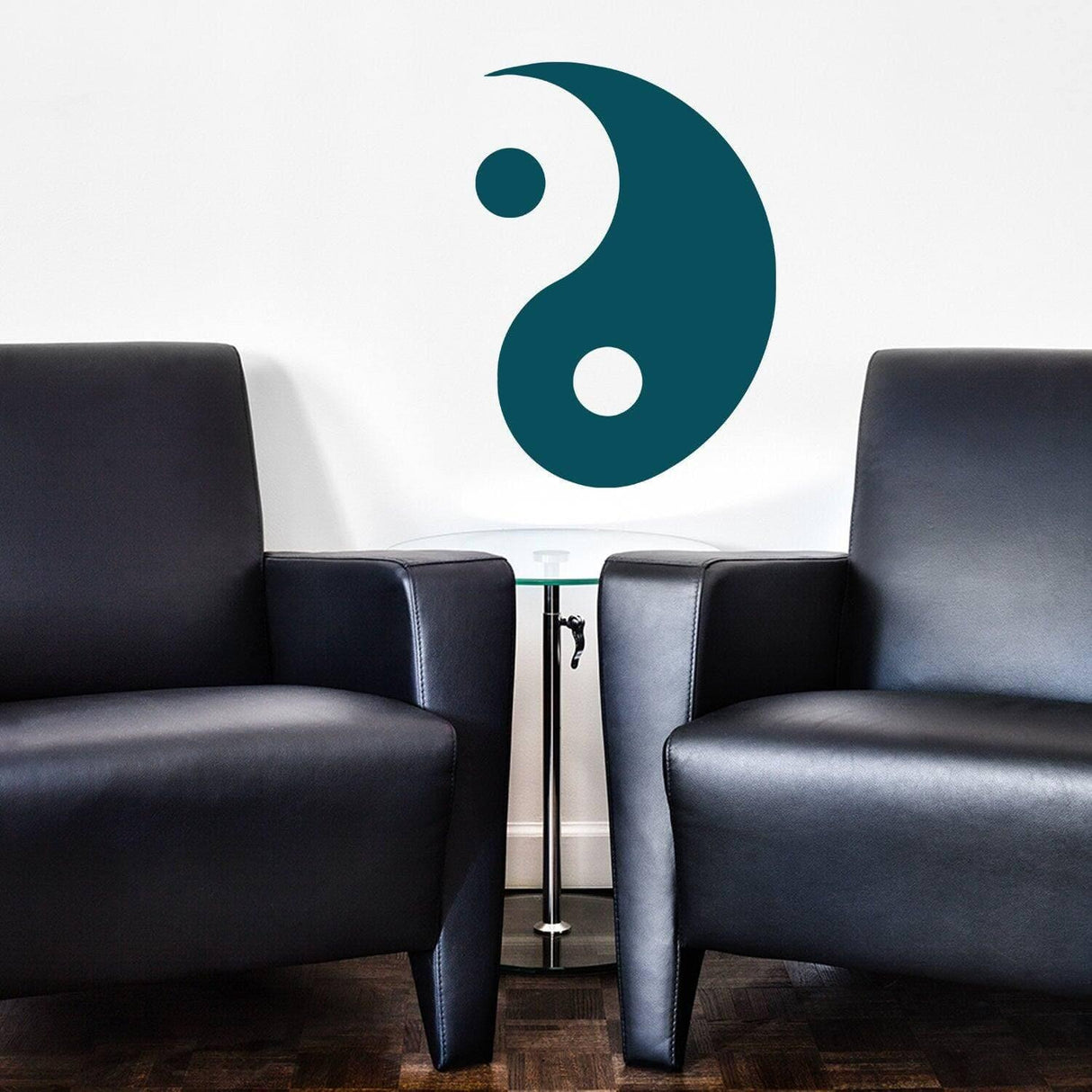 Prismatic Yin Yang wall decal on a white wall above two black chairs, symbolizing balance and tranquility in decor.