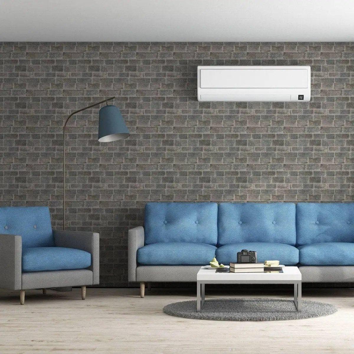 Modern living room with brick wall panel wallpaper, featuring blue couches and stylish decor.