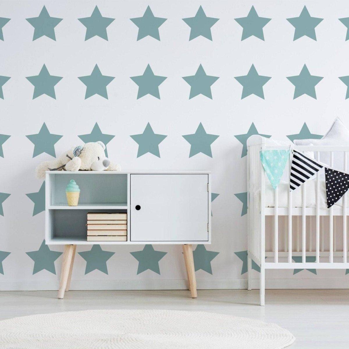 Nursery with teal star stickers on wall, modern crib, and playful decor for enchanting child's room.