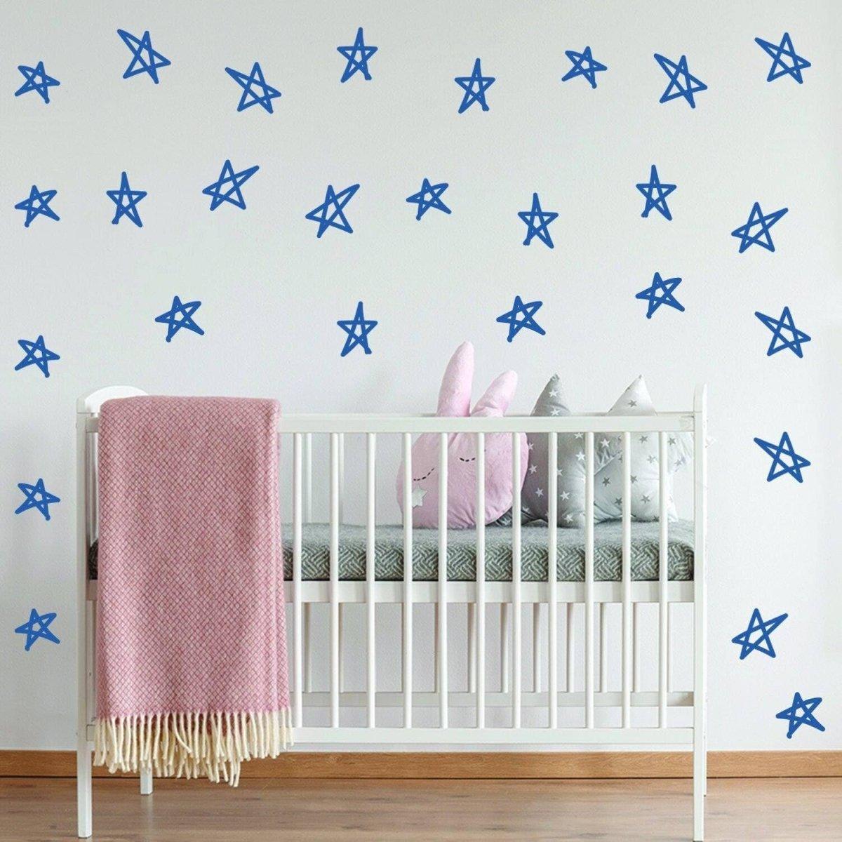 Blue star decals on a nursery wall, enhancing baby shower decorations with a whimsical touch.