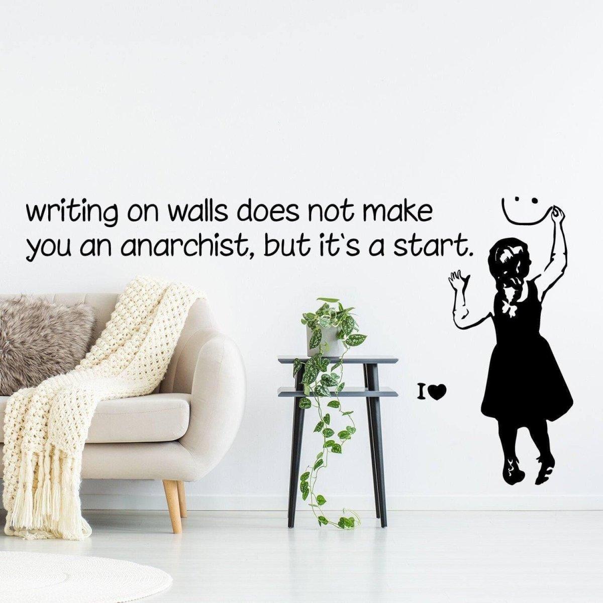 Banksy-style anarchist wall sticker with quote and girl drawing in modern living room decor.