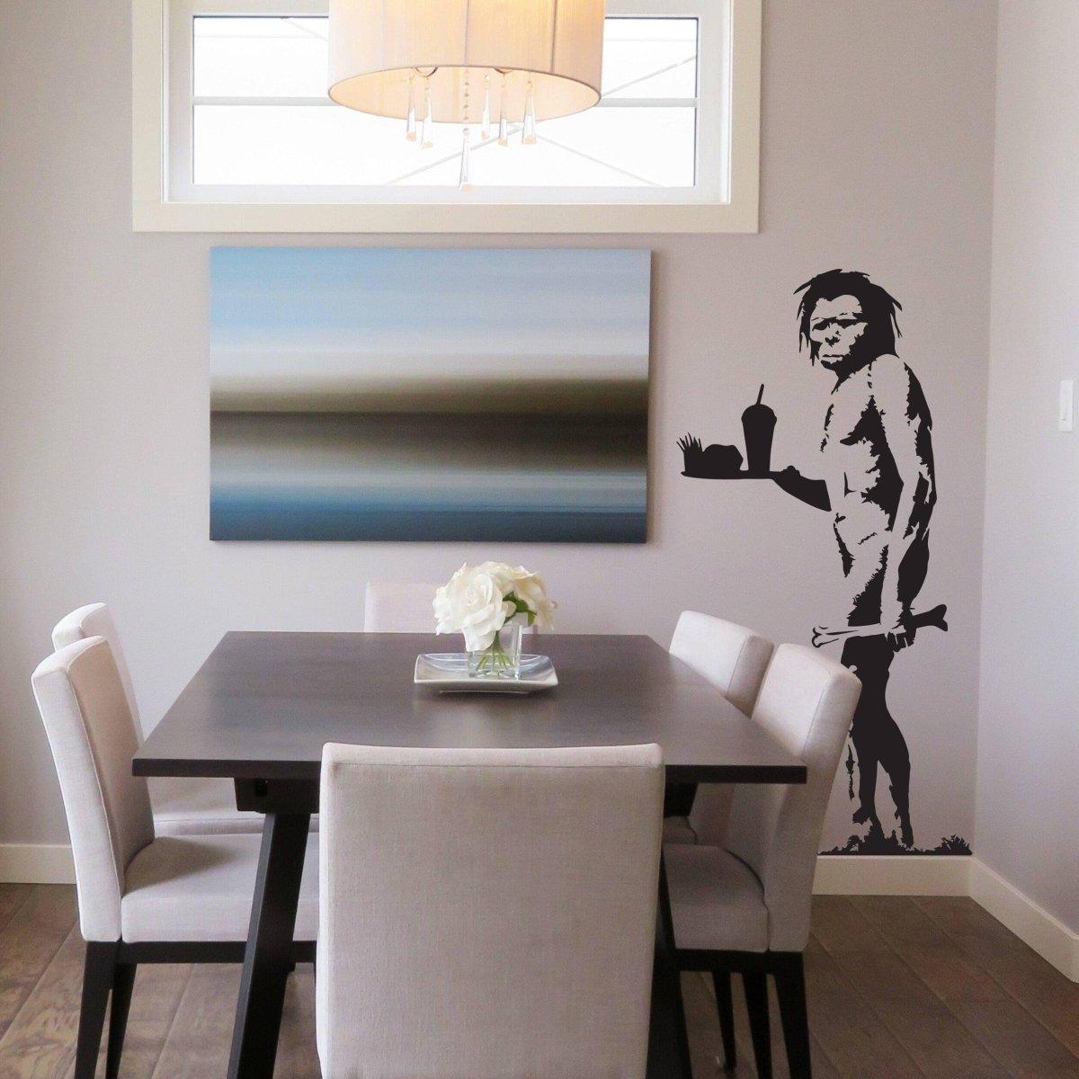 Caveman jokes vinyl wall sticker in a modern dining room with abstract art and stylish furniture.