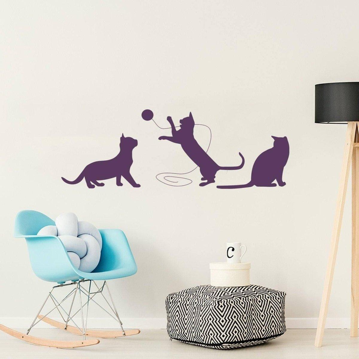 Adorable cat silhouette decal featuring three playful cats on a wall, perfect for pet-themed decor.