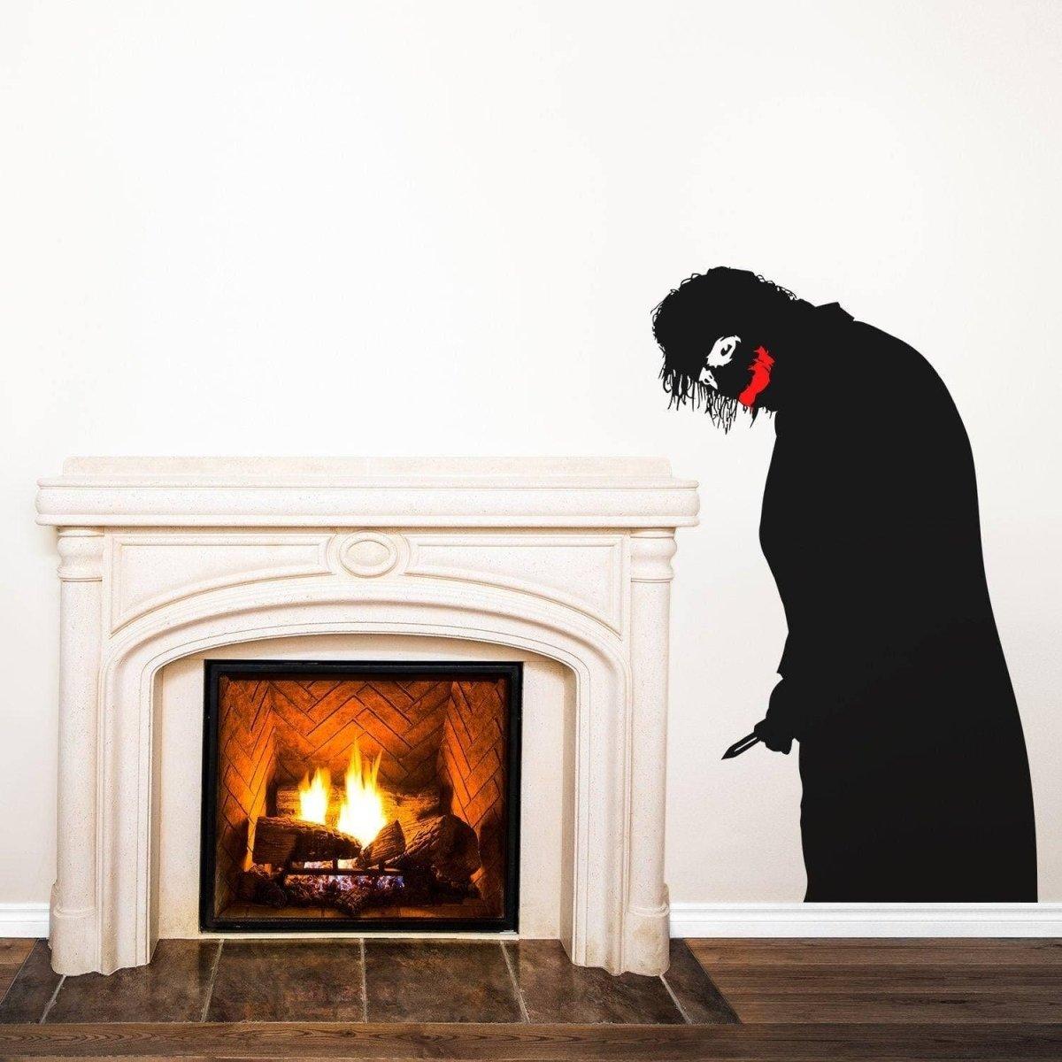Creepy clown vinyl decal with menacing smile beside a fireplace, adding a spooky touch to home decor.