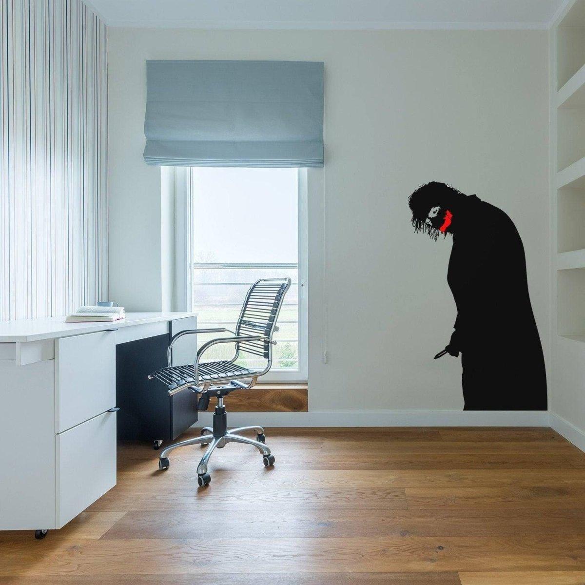 Creepy clown vinyl decal with menacing smile on wall in a modern office space.