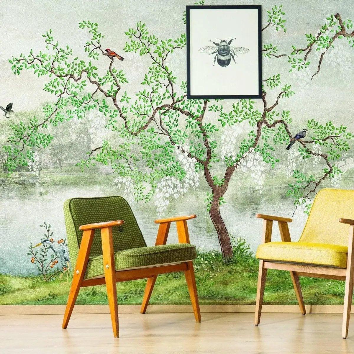 Dreamy chinoiserie wallpaper featuring lush trees and birds with stylish chairs in a cozy interior decor setting.