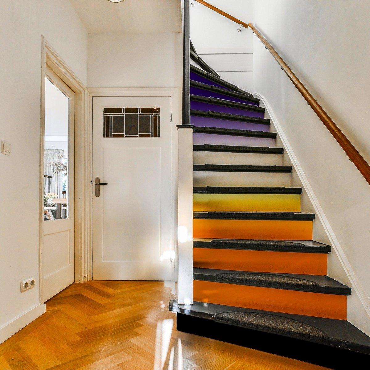 Vibrant staircase featuring gradient color riser stickers for a colorful home transformation.
