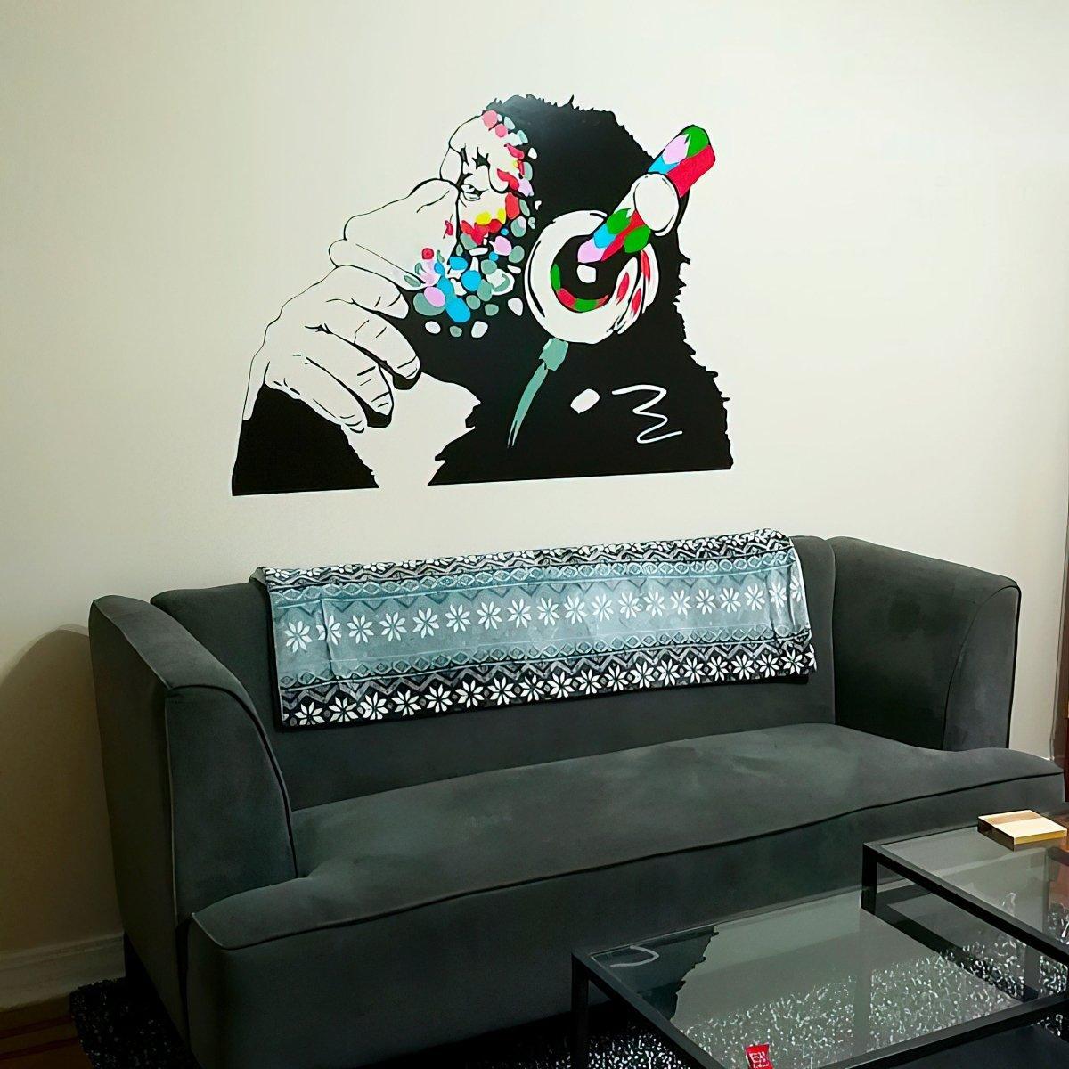 Contemplative monkey wall decal with headphones, adding a fun touch to a kids' room or office decoration.