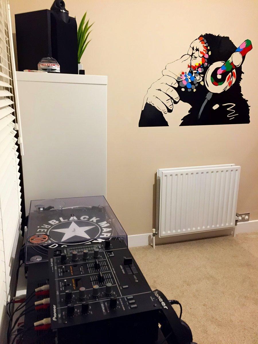 Cool monkey wall decal with headphones in a stylish music room, perfect for kids' decor and music lovers.