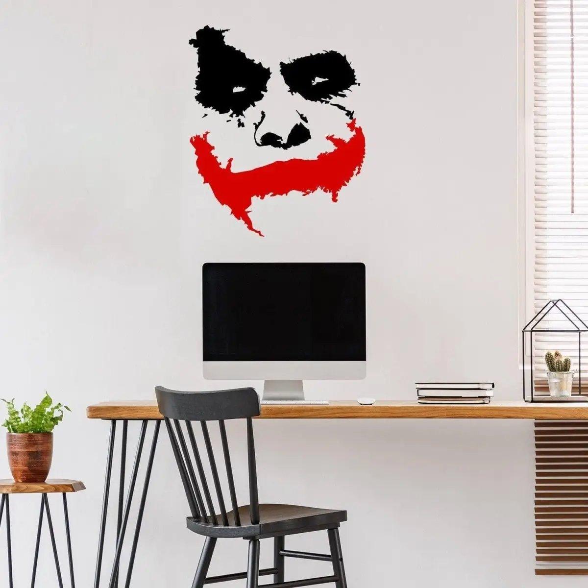 Joker Grin Decal featuring a creepy clown face vinyl wall sticker in a stylish workspace setting.