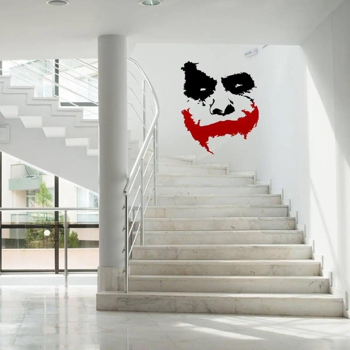 Joker grin vinyl wall sticker on a modern staircase, adding a creepy vibe to the interior decor.