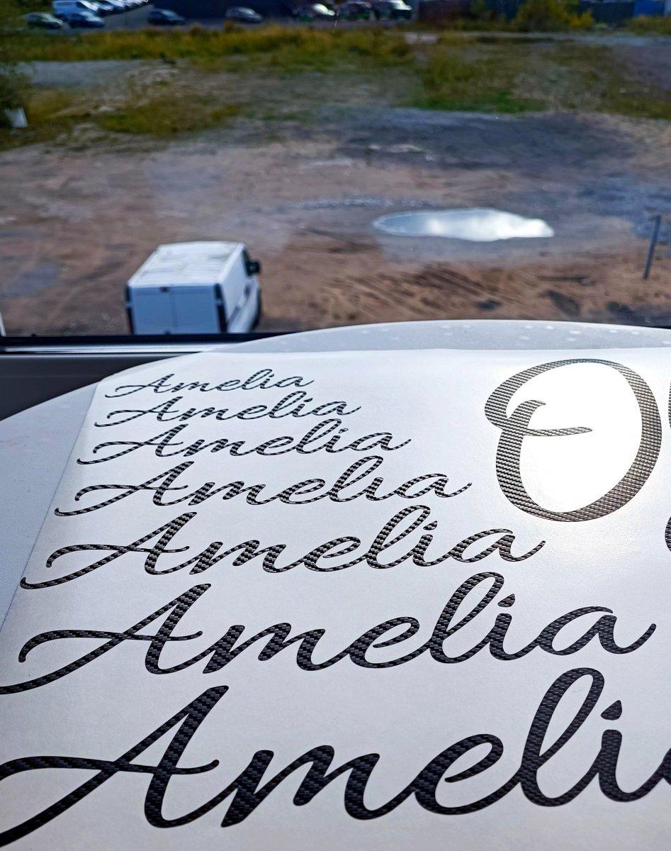 Personalized carbon fiber letter stickers featuring the name 'Amelia' in various stylish fonts.